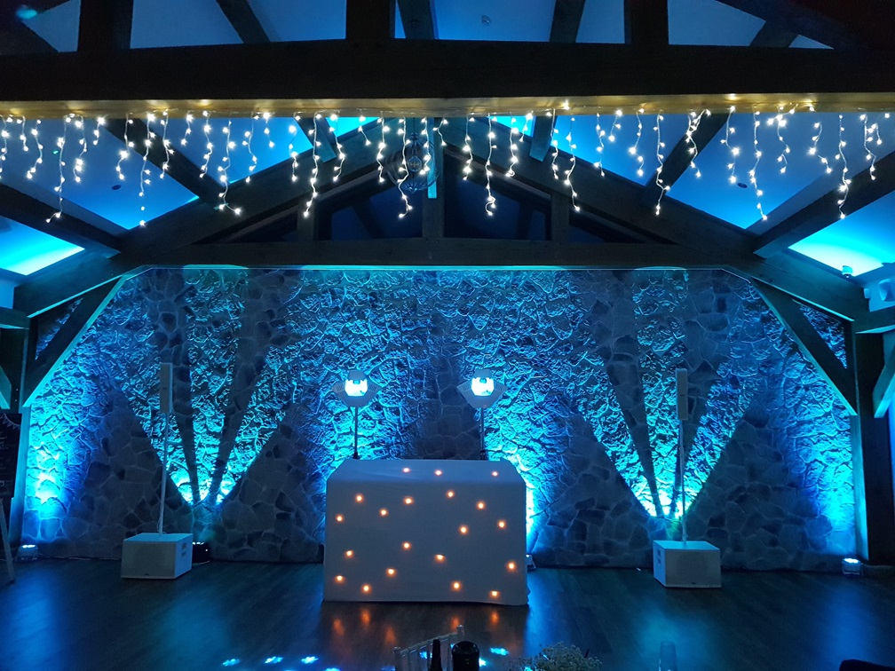 Professional mobile disco setup with bright dance floor lighting and DJ booth in Norfolk