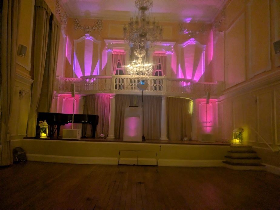 A professional DJ setup with uplighting at a wedding reception by YourNorfolkParty
