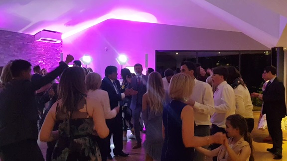 Wedding guests having fun dancing to the mobile disco at a wedding reception