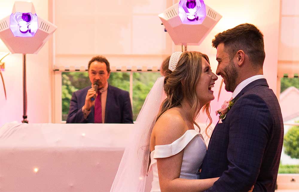 Professional wedding DJ setup with heart-shaped lighting in a Norfolk venue